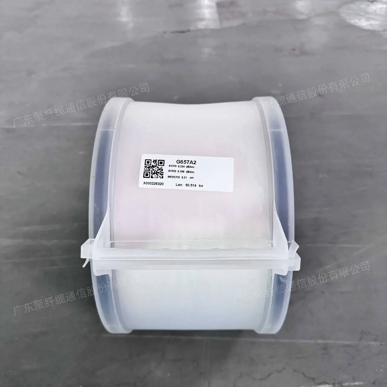Spool of optical fibre in a clear plastic housing with a label at a manufacturer's warehouse in China